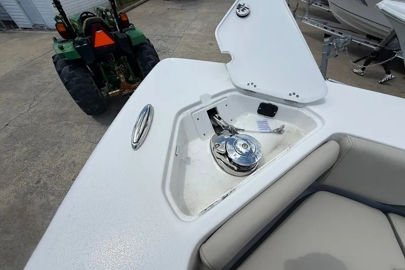 Slide: The Image of 2027 Key West 249 FS boat anchor compartment with open hatch, showing winch mechanism. - 23