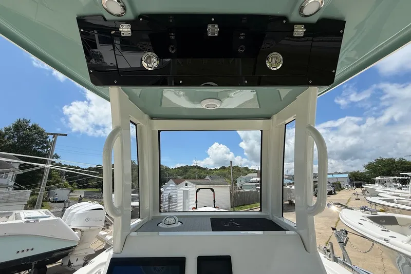 Slide: The Image of 2027 Key West 249 FS boat interior with clear sky view and modern controls. - 14