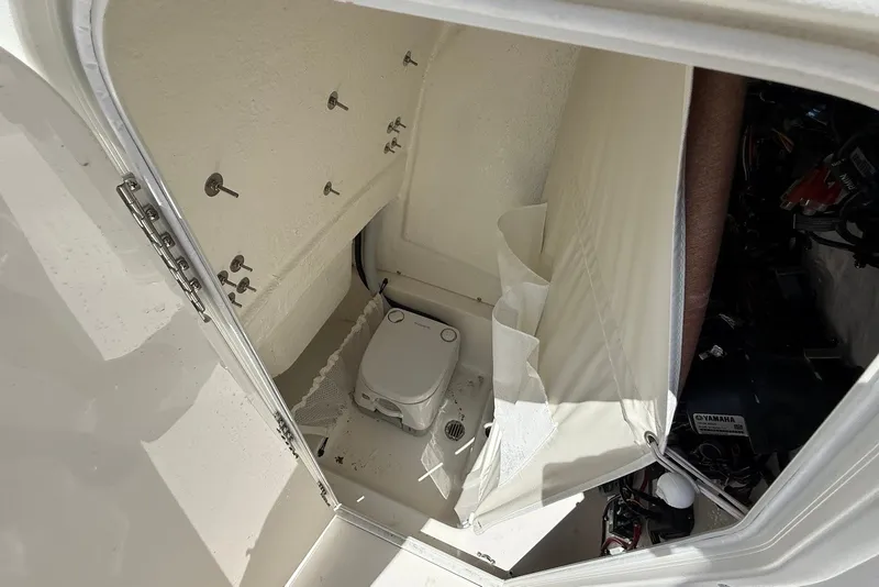 Slide: The Image of Interior of 2027 Key West 249 FS boat showing compact marine toilet setup. - 17