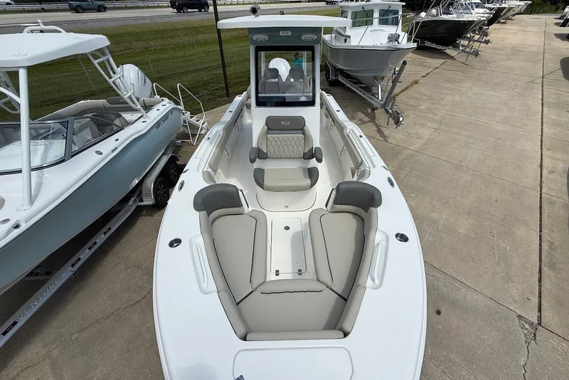 Slide: The Image of 2027 Key West 249 FS boat with spacious seating, displayed outdoors on a concrete surface. - 24