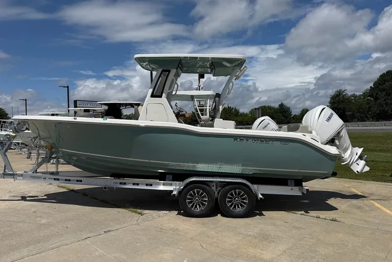 The Image of 2027 Key West 249 FS boat on trailer under blue sky. - 0
