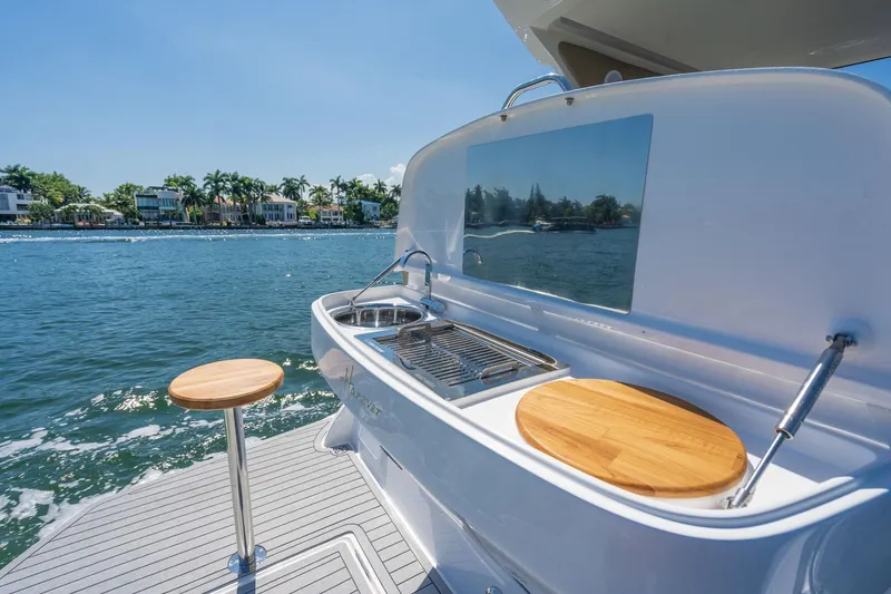 Slide: The Image of Outdoor kitchen on Hanover 375 yacht, 2026 model, with scenic waterfront view. - 30