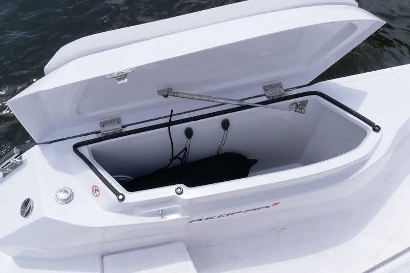 Slide: The Image of Open storage compartment on 2026 Axopar 29 XC Cross Cabin boat. - 22