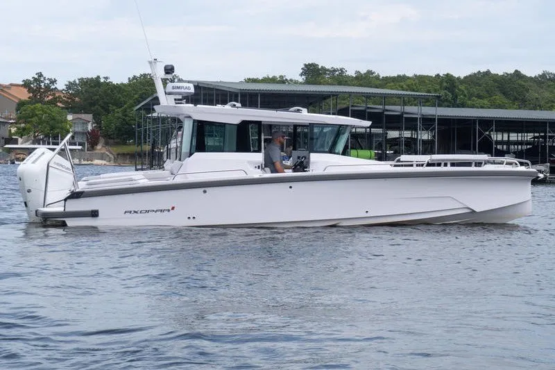 The Image of 2026 Axopar 29 XC Cross Cabin boat on water near marina. - 0