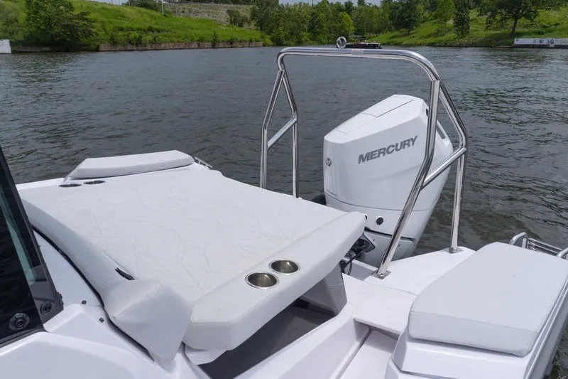 Slide: The Image of 2026 Axopar 29 XC Cross Cabin boat with Mercury engine on a serene lake. - 18