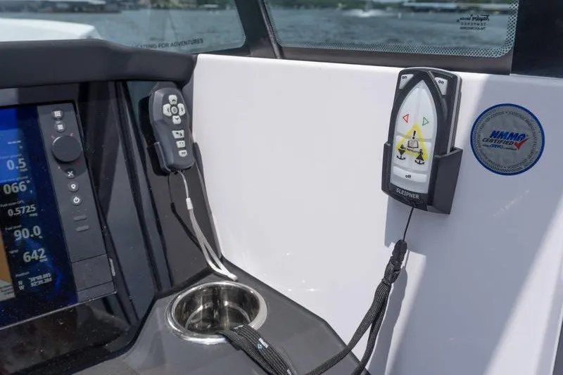 Slide: The Image of Control panel of 2026 Axopar 29 XC Cross Cabin with navigation display and remote. - 16
