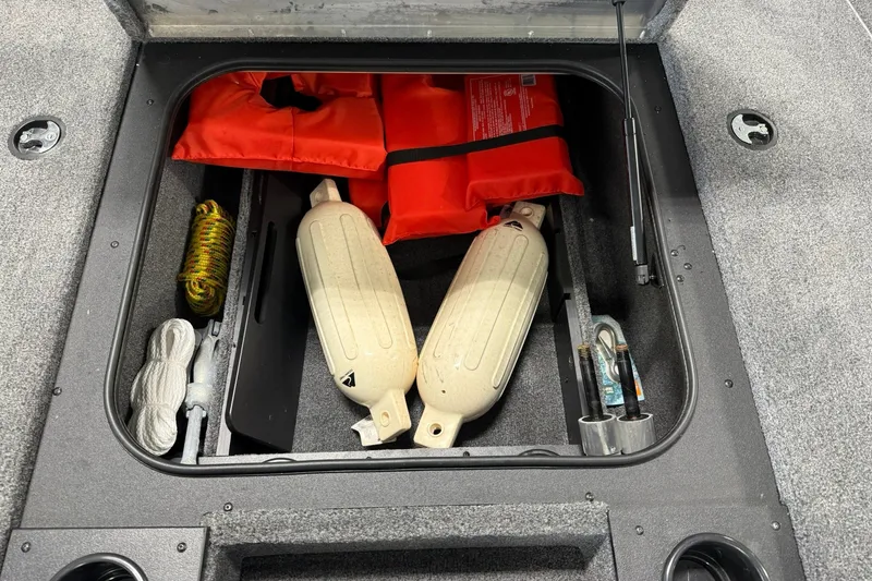 Slide: The Image of Storage compartment of 2024 Tracker Pro Team 175 TXW Tournament Edition with safety gear and ropes. - 19