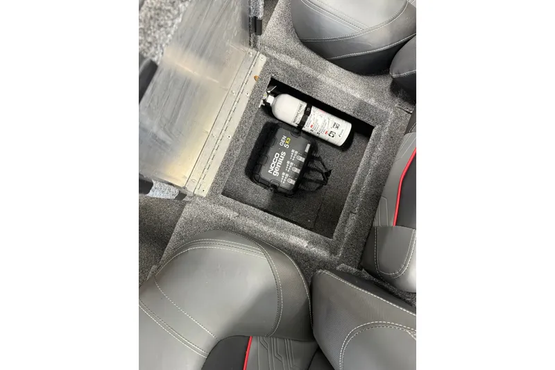Slide: The Image of Storage compartment in 2024 Tracker Pro Team 175 TXW Tournament Edition boat, featuring safety equipment. - 18