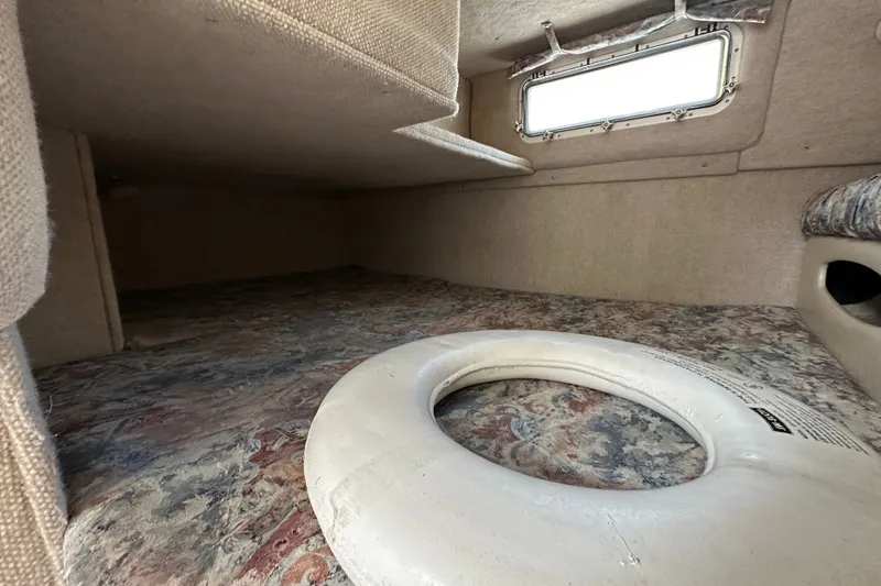 Slide: The Image of Interior cabin of 2000 Wellcraft 2600 Martinique boat with life preserver. - 16