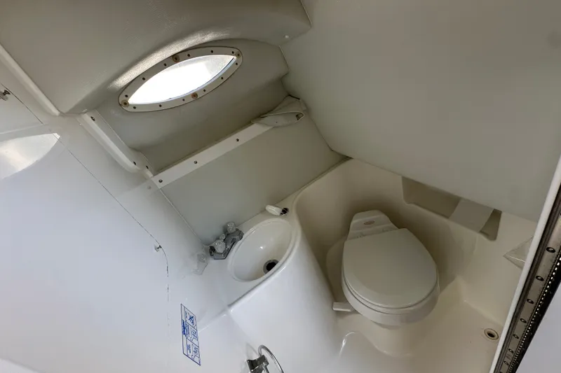 Slide: The Image of Compact bathroom in 2000 Wellcraft 2600 Martinique boat with toilet and sink. - 17
