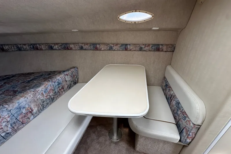 Slide: The Image of Interior of 2000 Wellcraft 2600 Martinique boat with cozy seating and table. - 13