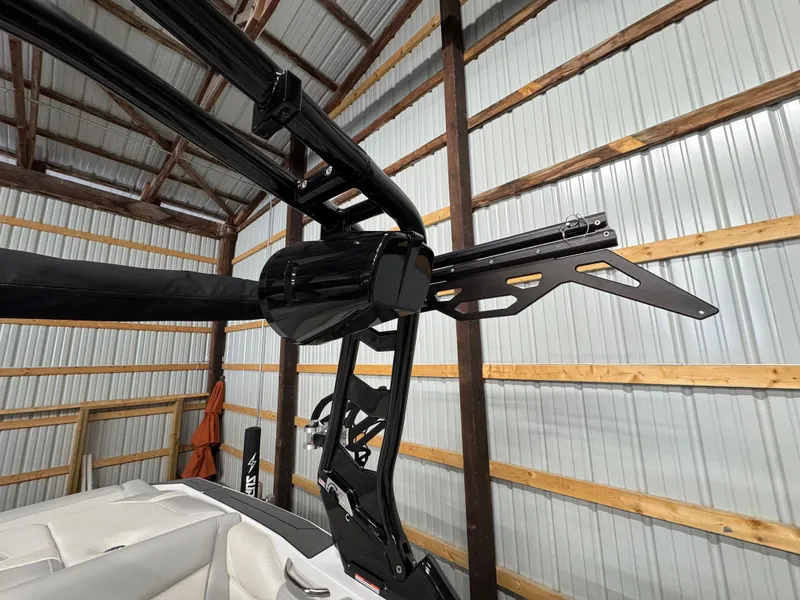 Slide: The Image of 2025 Supreme S220 boat interior with sleek black tower in a metal shed. - 10