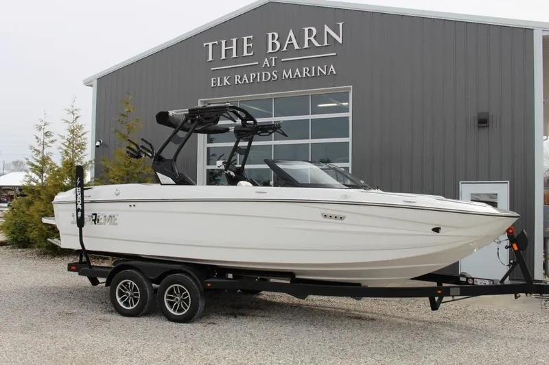 Slide: The Image of 2025 Supreme S220 boat on trailer at Elk Rapids Marina. - 0