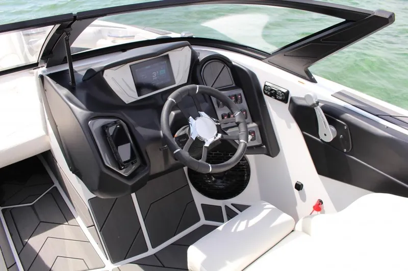 Slide: The Image of 2025 Supreme S220 boat cockpit with modern steering and control panel on water. - 3