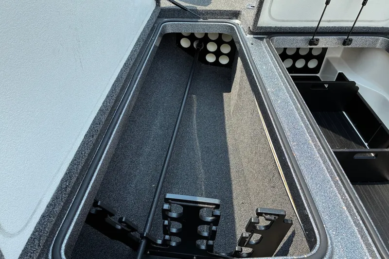 Slide: The Image of 2020 Ranger Z185 boat storage compartments with rod holders and organized interior layout. - 20