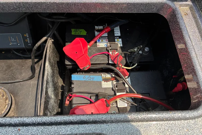 Slide: The Image of Battery compartment of a 2020 Ranger Z185 boat with visible wiring and connections. - 26