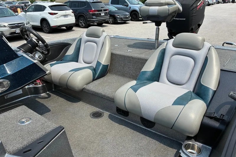 Slide: The Image of 2020 Ranger Z185 boat interior with dual seats and steering wheel, parked in a lot. - 14