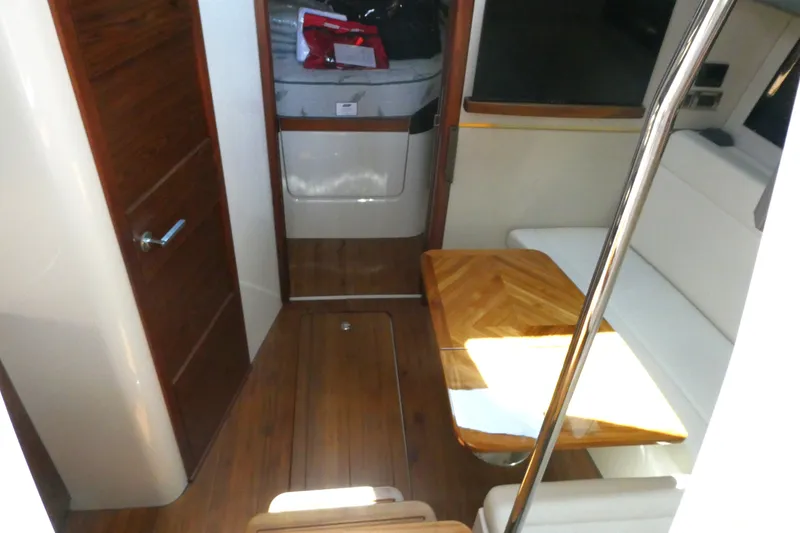 Slide: The Image of Interior of 2026 Boston Whaler 405 Conquest with wooden flooring and seating area. - 20