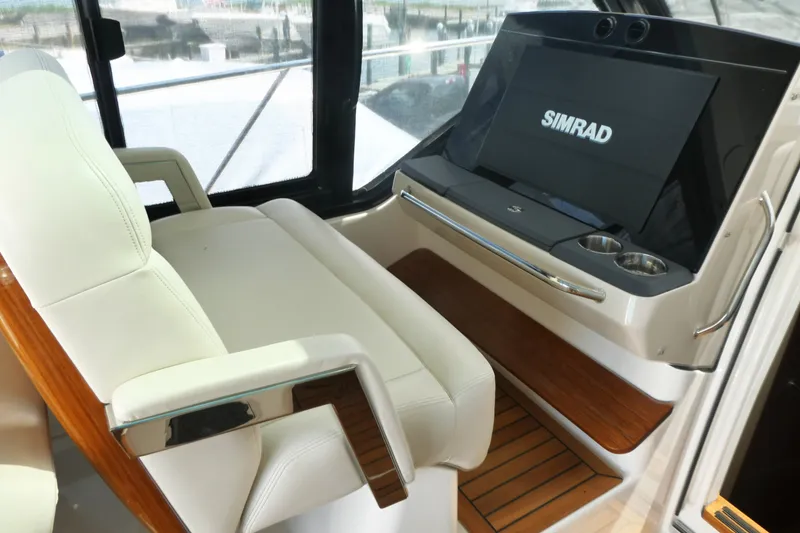 Slide: The Image of Luxurious helm seating and Simrad display on 2026 Boston Whaler 405 Conquest boat. - 18