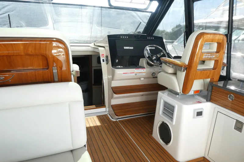 Slide: The Image of Interior of 2026 Boston Whaler 405 Conquest, featuring luxurious helm and seating area. - 17