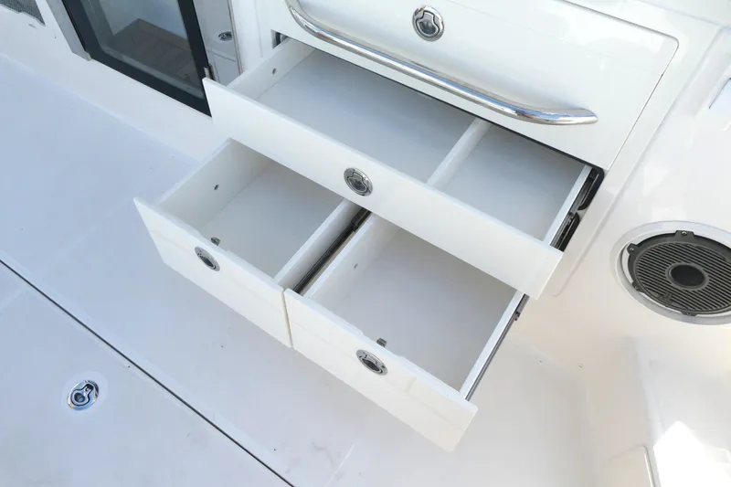 Slide: The Image of Open storage drawers on a 2026 Boston Whaler 405 Conquest boat interior. - 12