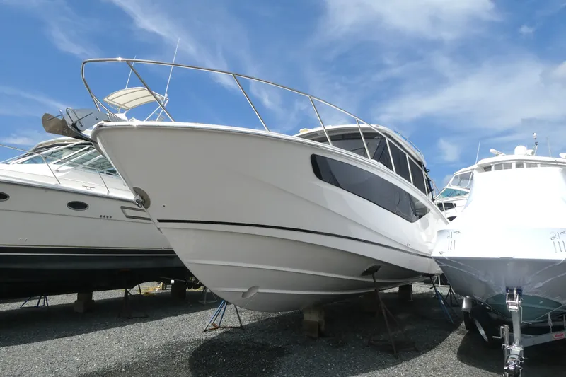 Slide: The Image of 2026 Boston Whaler 405 Conquest boat on display under a clear blue sky. - 2