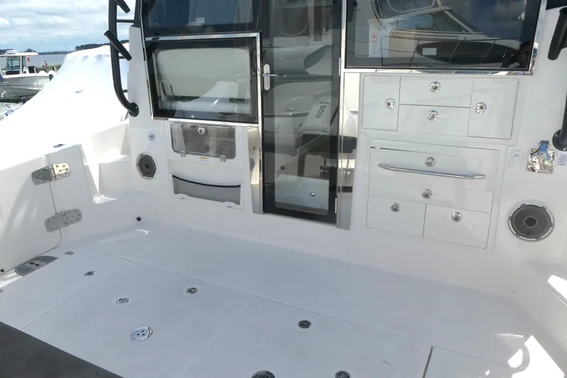 Slide: The Image of 2026 Boston Whaler 405 Conquest boat interior with storage compartments and sleek design. - 9