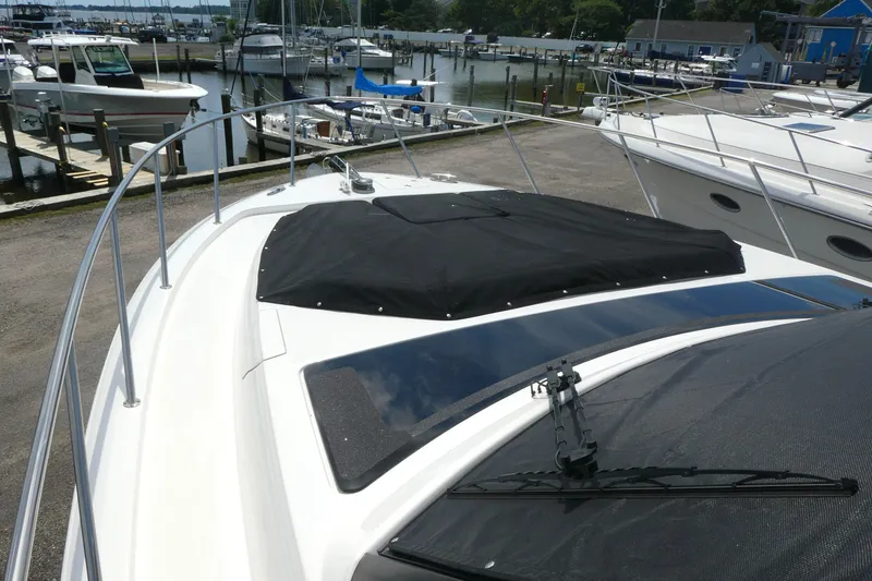 Slide: The Image of Boston Whaler 405 Conquest 2026 boat deck view at marina with covered hatch. - 4