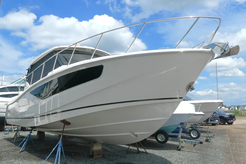 Slide: The Image of 2026 Boston Whaler 405 Conquest boat on display under a clear blue sky. - 1