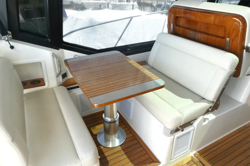 Slide: The Image of Luxurious interior of 2026 Boston Whaler 405 Conquest with elegant seating and wooden table. - 15