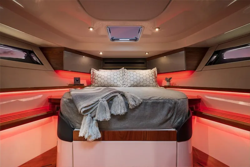 Slide: The Image of Manufacturer Provided Image: Luxurious cabin interior of 2026 Boston Whaler 405 Conquest with ambient lighting and cozy bedding. - 28