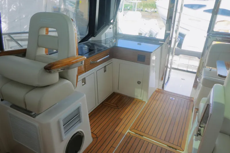 Slide: The Image of Interior of 2026 Boston Whaler 405 Conquest with luxurious seating and wooden flooring. - 13