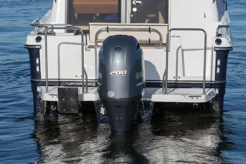 Slide: The Image of 2027 Ranger Tugs R-23 boat with Yamaha 200 outboard motor on water. - 8
