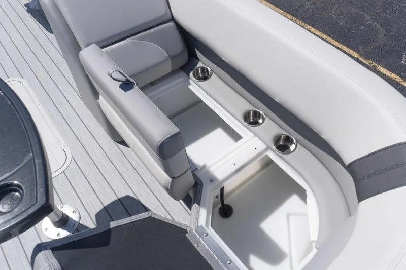 Slide: The Image of 2026 SunCatcher Select 322RC boat interior with storage and cup holders. - 17