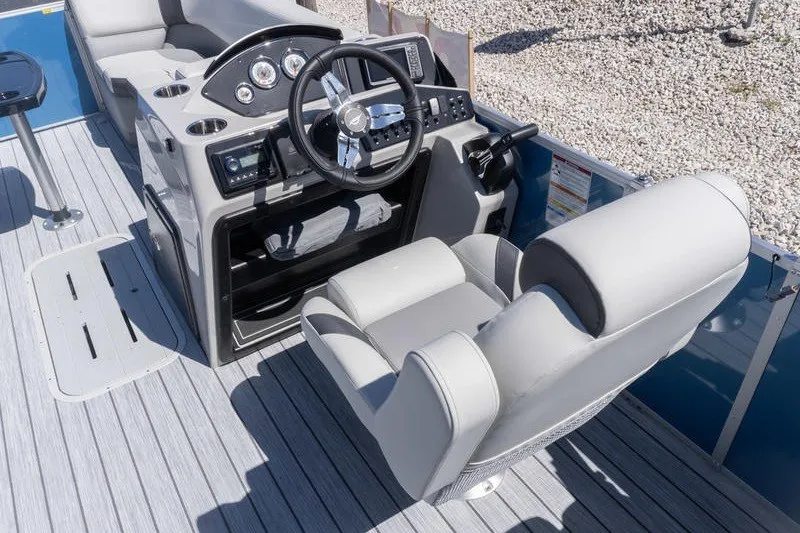Slide: The Image of 2026 SunCatcher Select 322RC boat interior with steering wheel and captain's chair. - 8