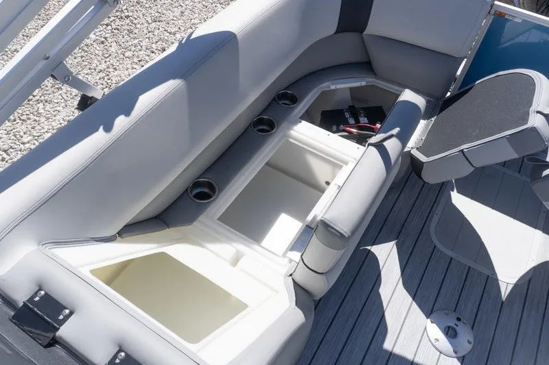 Slide: The Image of SunCatcher Select 322RC 2026 boat interior with open storage compartments and cup holders. - 23