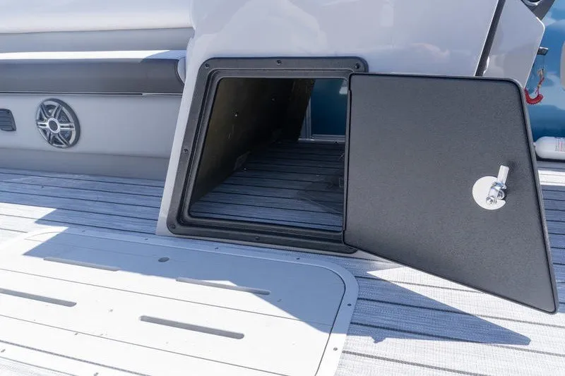 Slide: The Image of Open storage compartment on 2026 SunCatcher Select 322RC boat deck. - 11