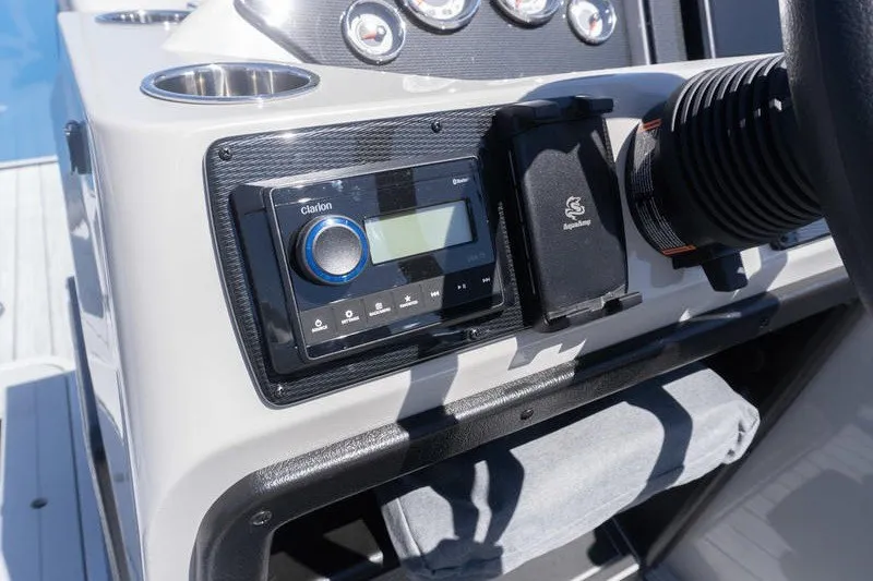 Slide: The Image of Dashboard of 2026 SunCatcher Select 322RC boat with audio controls and gauges. - 10