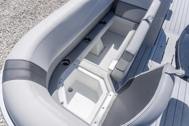 Slide: The Image of 2026 SunCatcher Select 322RC boat seating with storage compartments and cup holders. - 19