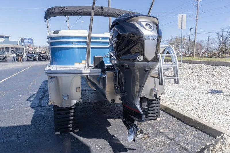 Slide: The Image of 2026 SunCatcher Select 322RC pontoon boat with powerful outboard motor, parked on pavement. - 3