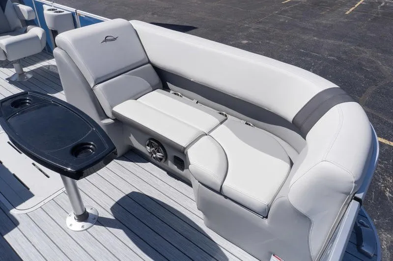 Slide: The Image of 2026 SunCatcher Select 322RC boat interior with gray seating and black table. - 16