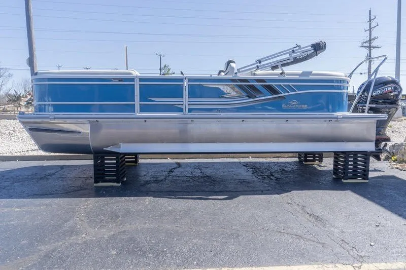 Slide: The Image of 2026 SunCatcher Select 322RC pontoon boat displayed on a lot. - 2