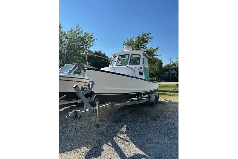 Slide: The Image of 2002 Eastern 22 Lobster Fisherman boat on trailer, parked outdoors under clear sky. - 2