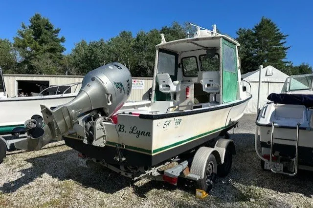 Slide: The Image of 2002 Eastern 22 Lobster Fisherman boat on trailer, parked outdoors under clear blue sky. - 4
