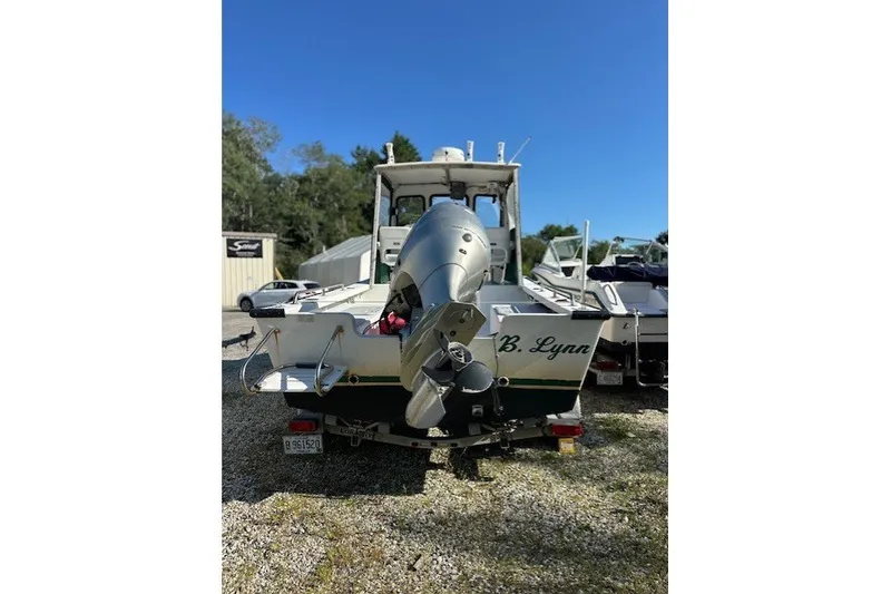 Slide: The Image of 2002 Eastern 22 Lobster Fisherman boat with outboard motor, parked on gravel. - 16
