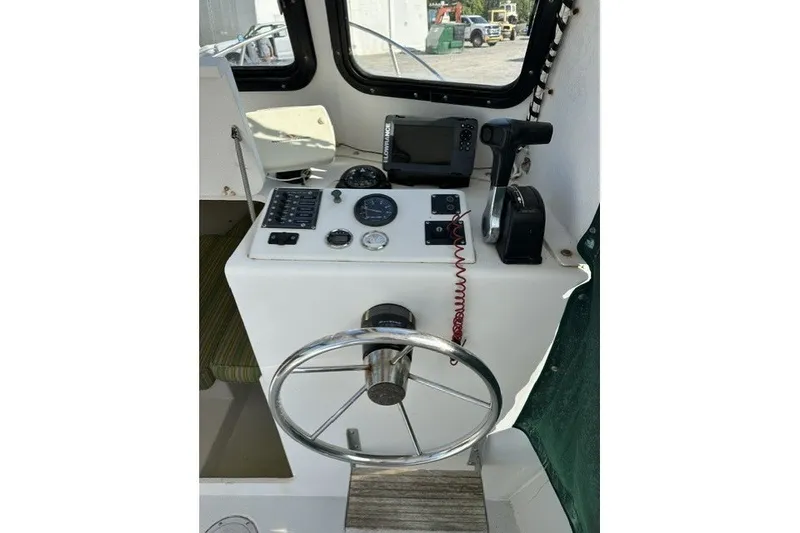 Slide: The Image of Helm of 2002 Eastern 22 Lobster Fisherman boat with steering wheel and navigation equipment. - 8