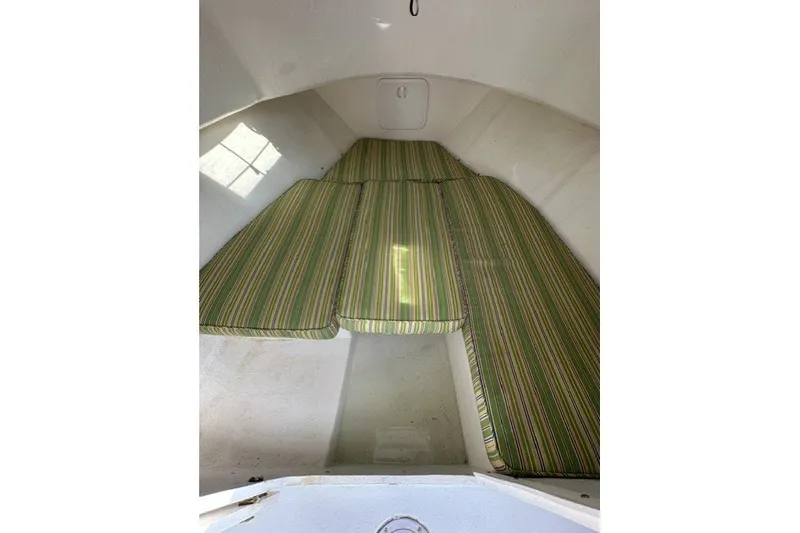 Slide: The Image of Interior cabin of a 2002 Eastern 22 Lobster Fisherman with striped cushions. - 11