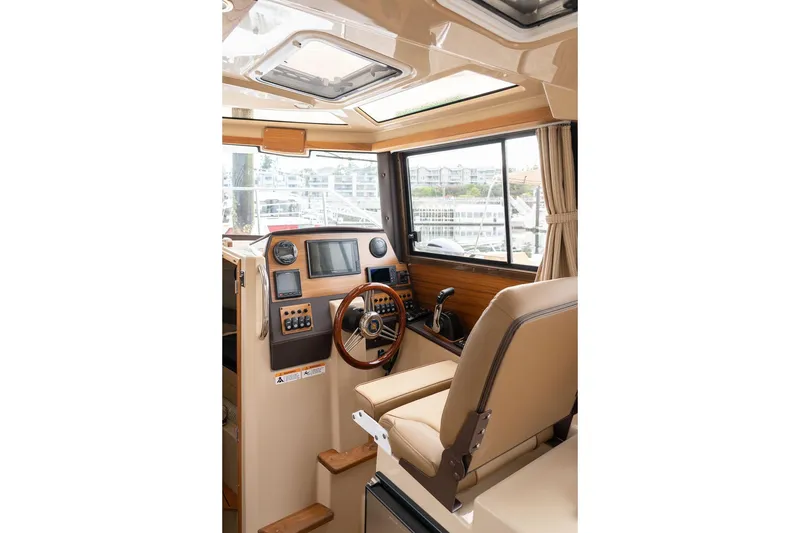 Slide: The Image of Interior of 2027 Ranger Tugs R-23 boat, featuring helm with modern controls and seating. - 25