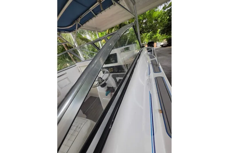 Slide: The Image of 2006 Twin Vee 26 Express boat interior with steering wheel and canopy. - 44