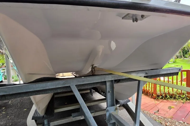 Slide: The Image of 2006 Twin Vee 26 Express boat hull on trailer, viewed from below. - 6